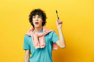 curly guy with a pencil in hand thought process isolated backgrounds photo