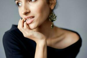 beautiful woman earrings jewelry posing black dress lifestyle studio photo