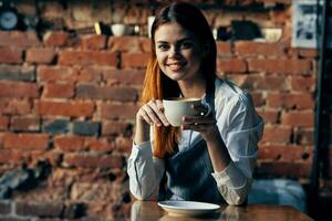 female waiter in apron coffee cup service ordering photo