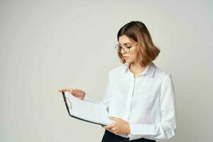 woman manager in white shirt with folder in hands documents office photo