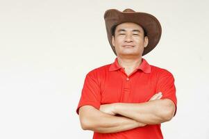 Asian man wears hat, red shirt, crossed arms on chest, feels confident. Copy space of adding text or advertisement. photo