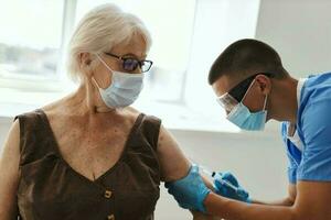 patient wearing medical mask next to doctor vaccination coronavirus covid-19 photo