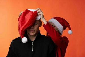 man and woman wearing christmas hats christmas holiday friendship photo