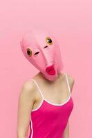 Modern Halloween costume in a silicone mask in the shape of a pink fish head in a sexy costume. The concept of a crazy look photo