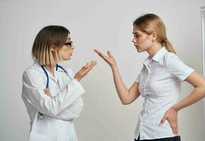 professional doctor with a stethoscope explaining something to a patient in a t-shirt photo