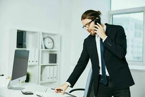 hombre en un traje un oficial es trabajando a el computadora tecnologías foto