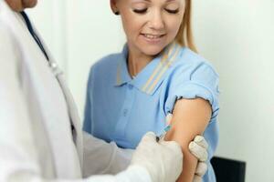 male doctor giving an injection to the patient's arm health vaccine photo