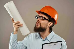 man in construction uniform orange helmet drawings documents work services photo