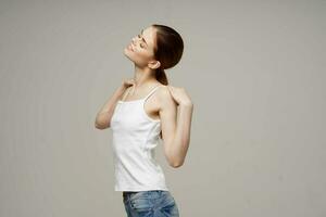 cheerful woman in white t-shirt warm-up shoulders health photo