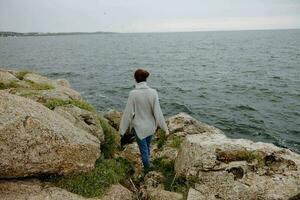 woman freedom walk on the stone coast Lifestyle photo