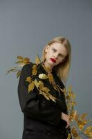 portrait of a woman decorations black jacket golden leaves studio model unaltered photo