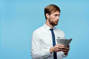 rich man in suit with money in hands emotions blue background photo