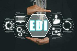 EDI, Electronic data interchange concept, Person hand holding Electronic data interchange icon on virtual screen. photo