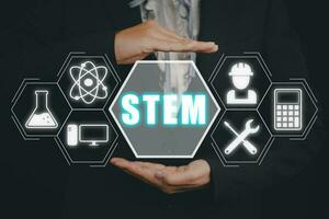 STEM concept, science, technology, engineering, mathematics, Businessman hand holding STEM icon on virtual screen. photo