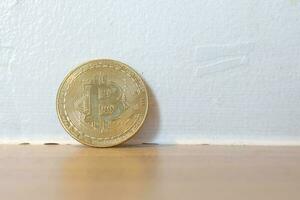 Close up of bitcoin on the wooden table background. Cryptocurrency trading concept photo