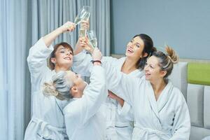 Girls with wine at spa party in the hotel photo