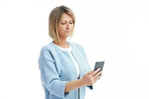 Picture of blonde woman over back isolated background with mobile phone photo
