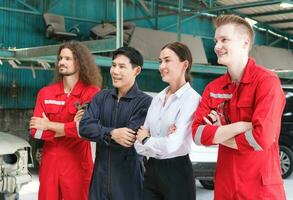 Portrait of confident managers and auto mechanic team standing with arms crossed in a repair garage, Car repair and maintenance concepts photo