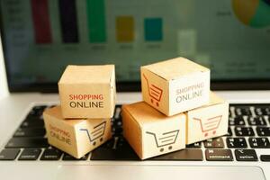 Online shopping, Shopping cart box on laptop with graph, import export, finance commerce. photo