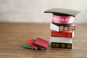 Graduation hat on book with copy space, learning university education concept. photo