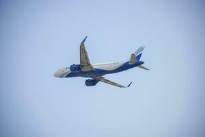 New Delhi, India, April 16 2023 - Indigo Airbus A320 take off from Indra Gandhi International Airport Delhi, Indigo domestic aeroplane flying in the blue sky during day time photo