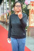 New Delhi, India - March 04 2023 - Unidentified people showing their ink-marked fingers after casting votes in front of polling booth of east Delhi area for MCD local body Elections 2022 photo