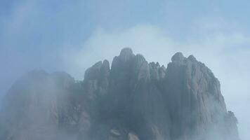 The beautiful mountains view surrounded by the misty fog in winter photo