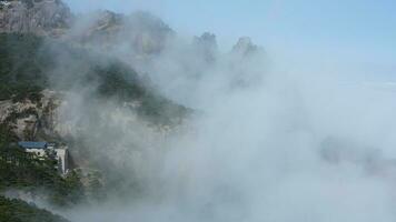 The beautiful mountains view surrounded by the misty fog in winter photo