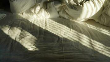 The morning sunlight projecting the window shadow on the bed photo