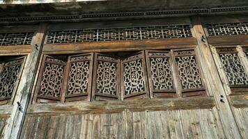 The old wooden Chinese house carved with the beautiful sculpture in the countryside village of the China photo