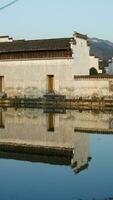 The beautiful traditional Chinese village view with the classical architecture and fresh green trees as background photo