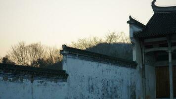 The beautiful traditional Chinese village view with the classical architecture and fresh green trees as background photo