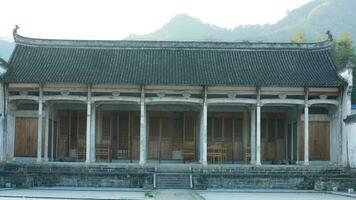 The beautiful traditional Chinese village view with the classical architecture and fresh green trees as background photo