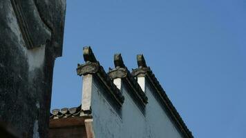 The beautiful traditional Chinese village view with the classical architecture and fresh green trees as background photo