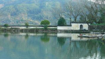 The beautiful traditional Chinese village view with the classical architecture and fresh green trees as background photo