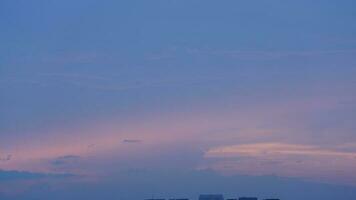 The beautiful sunset view with the buildings' silhouette and orange color sky as background in the city photo