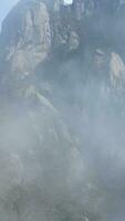 The beautiful mountains view surrounded by the misty fog in winter photo