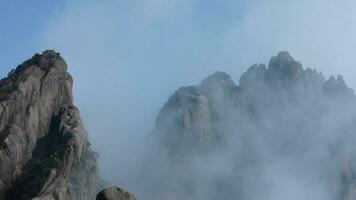 The beautiful mountains view surrounded by the misty fog in winter photo