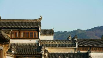 The beautiful traditional Chinese village view with the classical architecture and fresh green trees as background photo