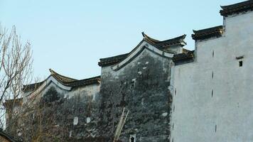 The beautiful traditional Chinese village view with the classical architecture and fresh green trees as background photo