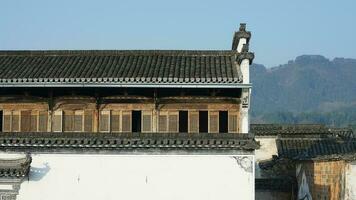 The beautiful traditional Chinese village view with the classical architecture and fresh green trees as background photo