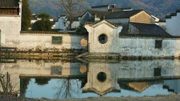 The beautiful traditional Chinese village view with the classical architecture and fresh green trees as background photo