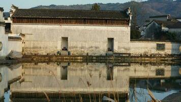 The beautiful traditional Chinese village view with the classical architecture and fresh green trees as background photo