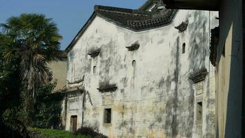 The beautiful traditional Chinese village view with the classical architecture and fresh green trees as background photo