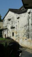 The beautiful traditional Chinese village view with the classical architecture and fresh green trees as background photo