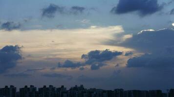 The beautiful sunset view with the buildings' silhouette and orange color sky as background in the city photo