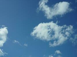 The beautiful sky view with the white clouds and blue sky as background in summer photo