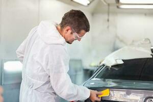 Repairman checking shades cards for car painting, Worker painter checking color matching before painting, Garage painting car service repair and maintenance photo