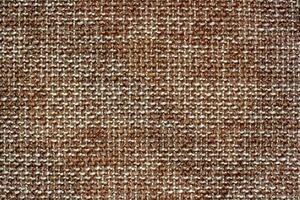 The texture of the fabric. Brown woolen interlaced fabric. Copy space photo