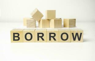 Borrow - word from wooden blocks with letters, to take the money and pay it back over a period of time borrow concept photo